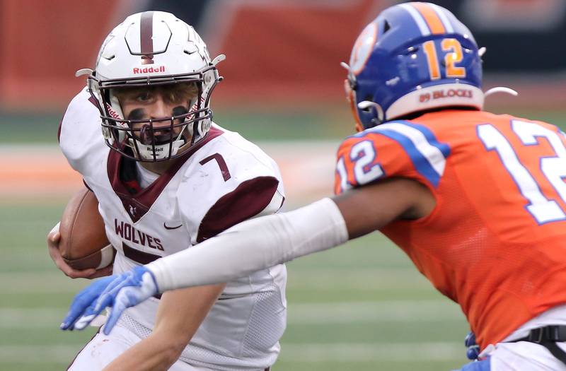 Prairie Ridge's Tyler Vasey tries to get by East St. Louis' Michael Tillman during their IHSA Class 6A state championship game Saturday, Nov. 26, 2022, in Memorial Stadium at the University of Illinois in Champaign.