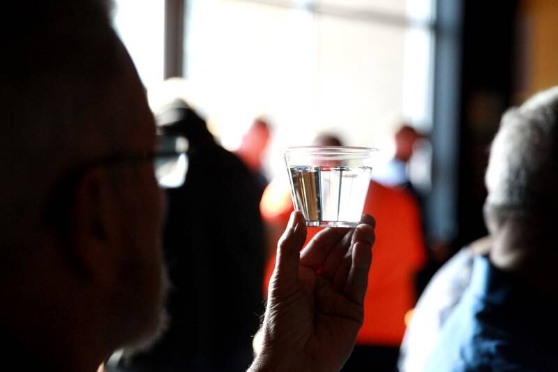 Dan Young of Batavia checks the clarity of water in a blind judging on Thursday, Dec. 19, 2024 during the annual Kane County Water Association's annual water tasting contest at Global Brew in St. Charles.