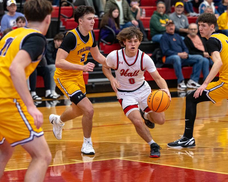Greyson Bickett (0) of Hall dribbles ball past Mendota's defense on Saturday, December 20, 2025 at Hall High School in Spring Valley.