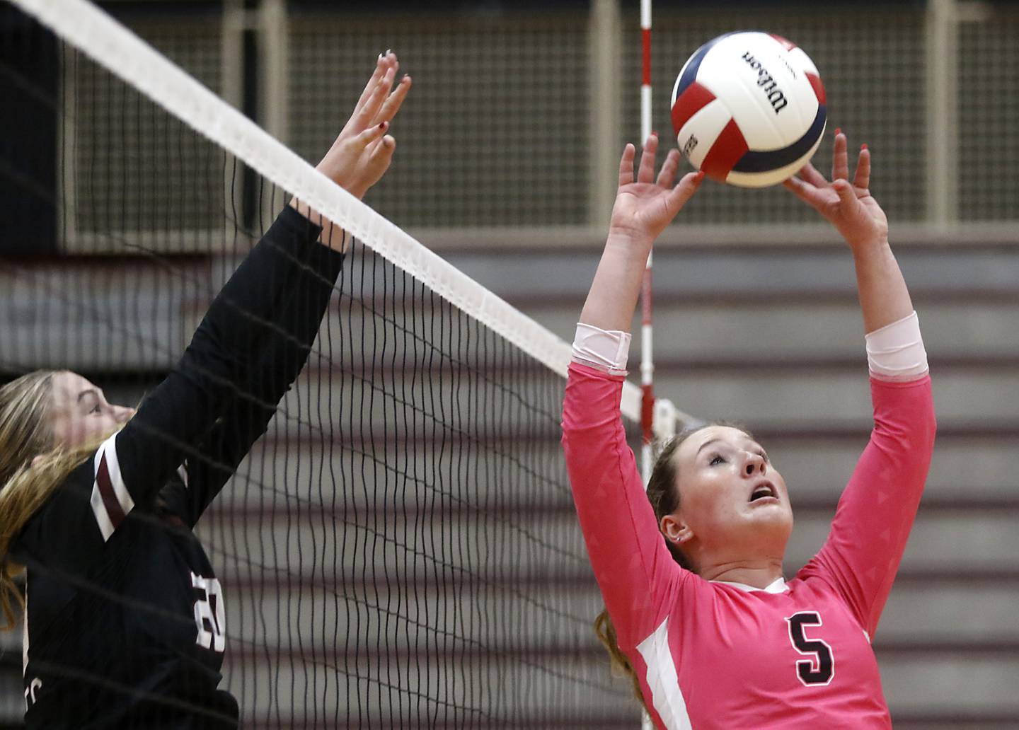 Huntley's Emily Ernst sets the ball as Prairie Ridge's Ava Bell tries to block the ball during a Fox Valley Conference volleyball match on Tuesday, Oct. 14, 2025, at the Prairie Ridge High School in Crystal Lake.