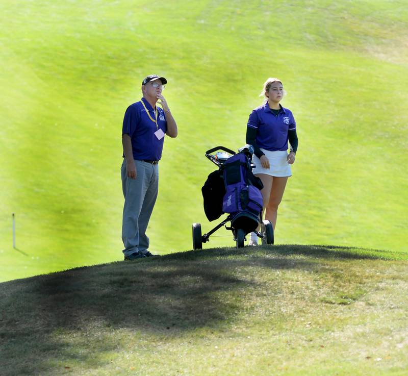 Dixon's Reese Dambman and her coach Lee Eastman strategize her approach to the 18th green during the 1A regional at Wolf Hollow Golf Course in Lena on Tuesday, Oct. 1, 2024. Dambman led Dixon with an 80.