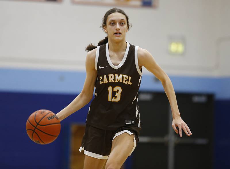 Carmel's Jordan Wood (13) brings the ball up court during the girls varsity basketball game between Carmel High School and Nazareth Academy on Wednesday, Dec. 7, 2022 in LaGrange, IL.