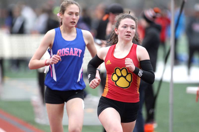 Batavia’s Katrina Schlenker leads Rosary’s Lianna Surtz in the 3200-meters during the Kane County Girls Invite at St. Charles East on Thursday, April 28, 2022.