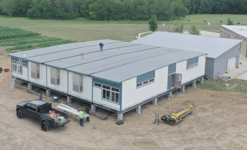 Crews install four 70 x 70 modular classrooms on the new property next to Waltham School on Monday, July 8, 2024 in Utica. The school, built in 2018, has already outgrown its 240 student capacity and placed the four classrooms next to the school.