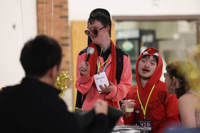 Westin Wenrenburg, center, hangs out with his friends at the annual Special Population Dance hosted by Joliet West high school on Friday, March 22, 2024.