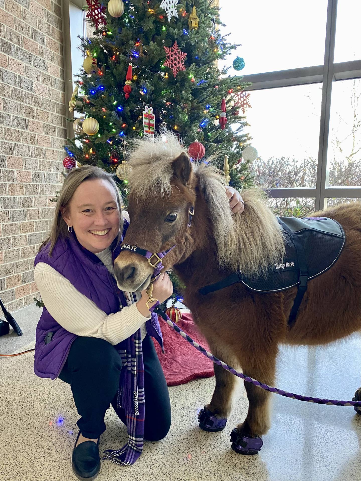 Lunar's purple shoes match those of her new friend during a visit Dec. 13 to Advocate Good Shepherd Hospital in Barrington.