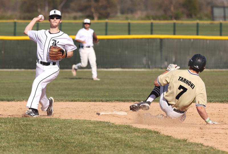 Kaneland’s Tom Thill tries to turn a double play as Sycamore's Kiefer Tarnoki slides in to break it up during their game Thursday, May 4, 2023, at Kaneland High School.