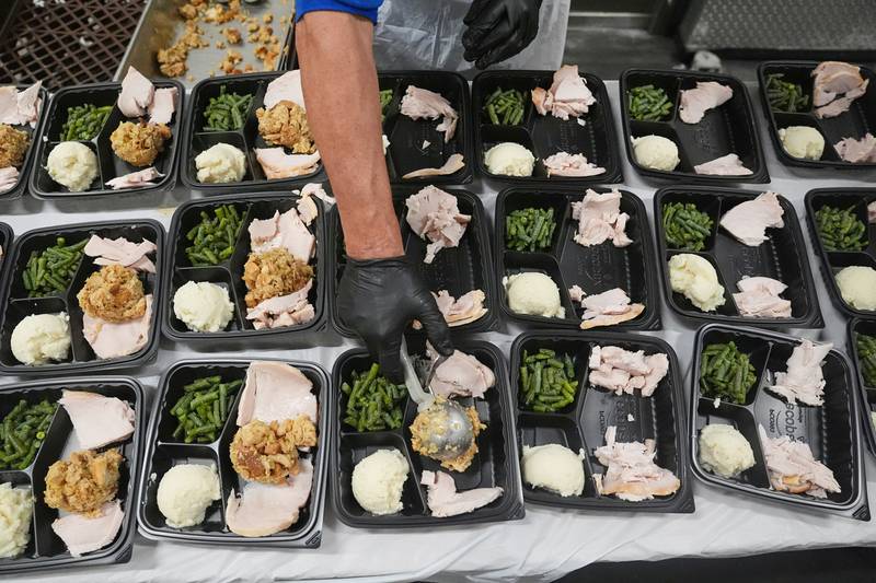 A volunteer prepares meals at the Philabundance Community Kitchen in Philadelphia, Thursday, Oct. 30, 2025. (AP Photo/Matt Rourke)