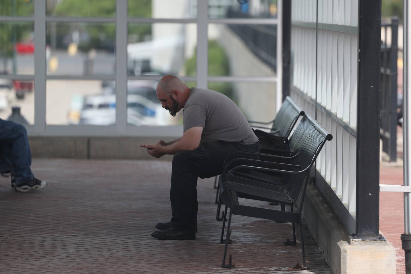 A commuter waits for a train at the Joliet Gateway Center station on Monday, May 15, 2023 in Joliet.