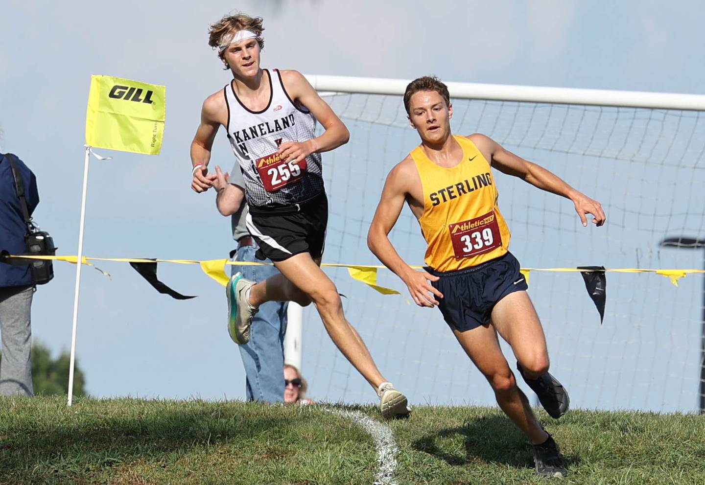 Kaneland’s Evan Nosek tries to run down Sterling’s Dale Johnson during the Sycamore Cross Country Invitational Tuesday, Aug. 29, 2023, at Kishwaukee College in Malta.