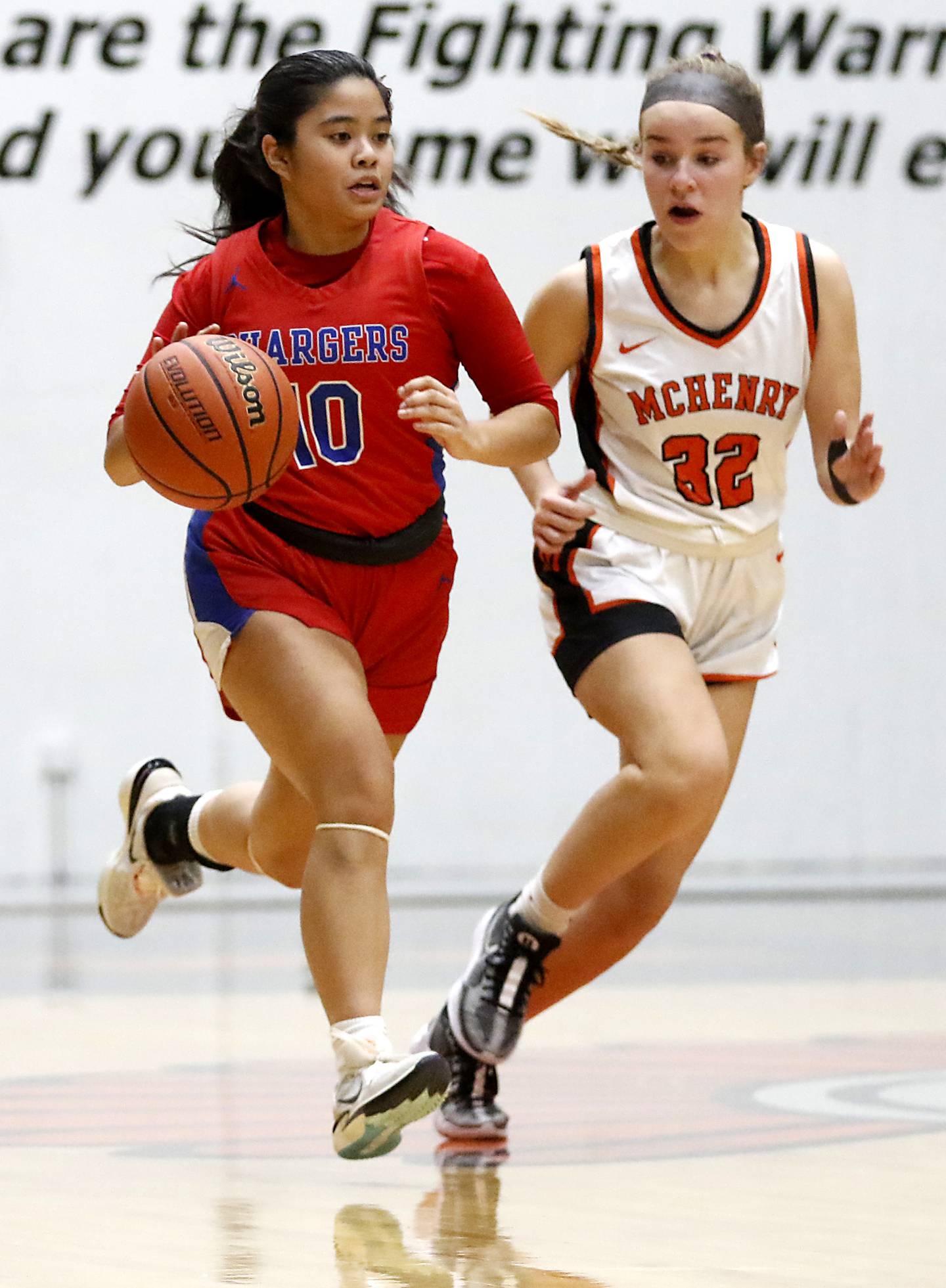 Dundee-Crown’s Theriz Mercado pushes the ball up the court against McHenry's Lucy Jones during a Fox Valley Conference girls basketball game on Tuesday, Dec. 12, 2023, at McHenry High School.