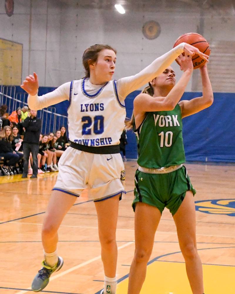 Lyons Township Ella Ormsby (20) tries to defend York Lizzie Baldridge (10)  during the first quarter Friday Feb. 3rd at Lyons Township High School.