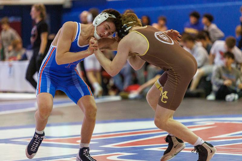 Marmion's Aidan McClure and Mt. Carmel's William Grafton - Hodgetts competes in the 132 lb match  at the Marmion Class  2A Dual Team Sectional on Thursday, Feb. 5,2026 in Aurora.