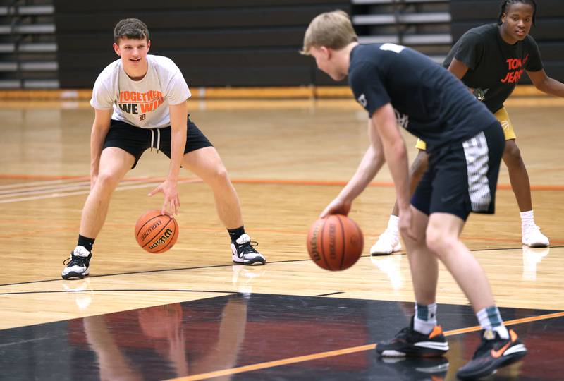 DeKalb’s Eric Rosenow (left) and Sean Reynolds participate in a ball handling drill during practice Monday, June 19, 2023, at DeKalb High School.
