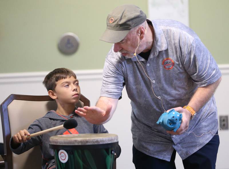 Eric Swanson shows Lincoln Elementary School student Kingstin Bosch a rhythm during a drum circle on Friday, Oct. 17, 2025 at Greenfield Retirement Home in Princeton. The drum circle was hosted by Eric Swanson of Chicago, through his business Drum Impact. The students learned how to make rhythm, play instruments, music therapy, collaboration and converse with the residents.