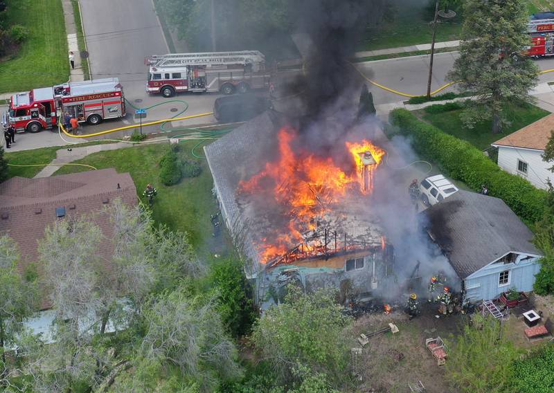 An aerial view of structure fire as flames pour out of the roof in the 1900 block of Main Street on Monday, May 4, 2026 in Peru.