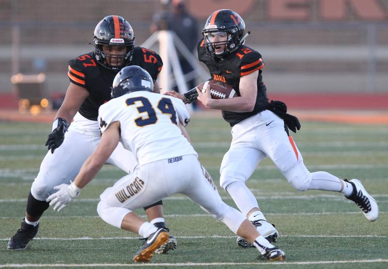 DeKalb quarterback Trenton Kyler looks for running room during their game Friday night against Neuqua Valley at DeKalb High School.