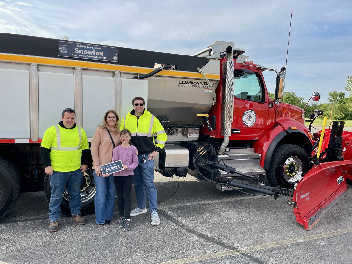 Kevin Kucharski of McHenry County Division of Transportation, left, Mary Endres Principal Christina Ruiz, Adalyn Krejci and Hans Varga of McHenry County Division of Transportation stand by Snowlax in Woodstock May 21, 2026
