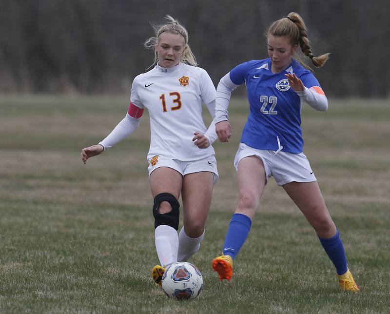 Richmond-Burton's Jordan Otto controls th ball in front of Woodstock's Reese Freund during a Kishwaukee River Conference soccer match Wednesday, April 30, 2022, between Richmond-Burton and Woodstock at Creekside Middle School.