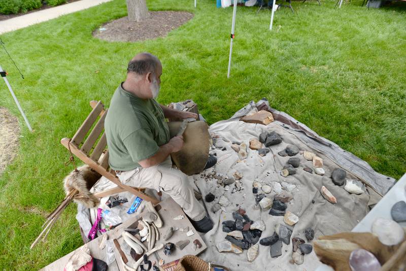 Alan Harrison of Dixon demonstrates how make flint knapping tools used by Native Americans at the Elmhurst Historical Museum during Museum Day held Sunday, May 15, 2022.