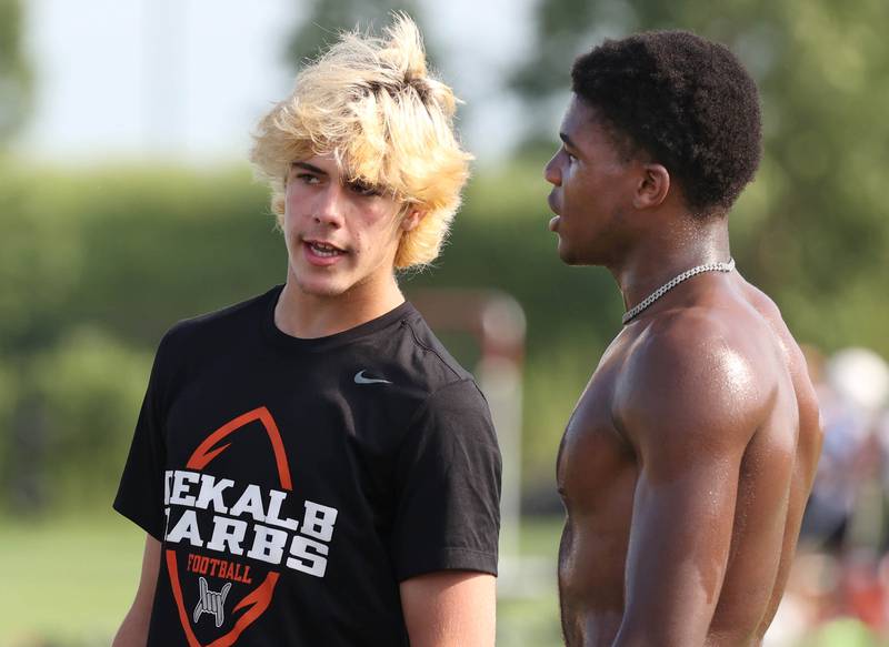 DeKalb’s Cole Latimer (left) talks to teammate Davon Grant on the sidelines Tuesday, July 16, 2024, during their matchup with Woodstock North in the Kaneland 7-on-7 at the school in Maple Park.