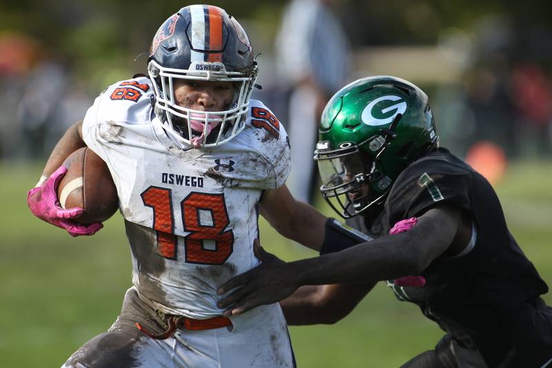 Oswego's Jordan Katzenbach (18) is tackled by Glenbard West's JT Thomas during a Class 8A first-round playoff game in Glen Ellyn on Saturday, Oct. 30, 2021.