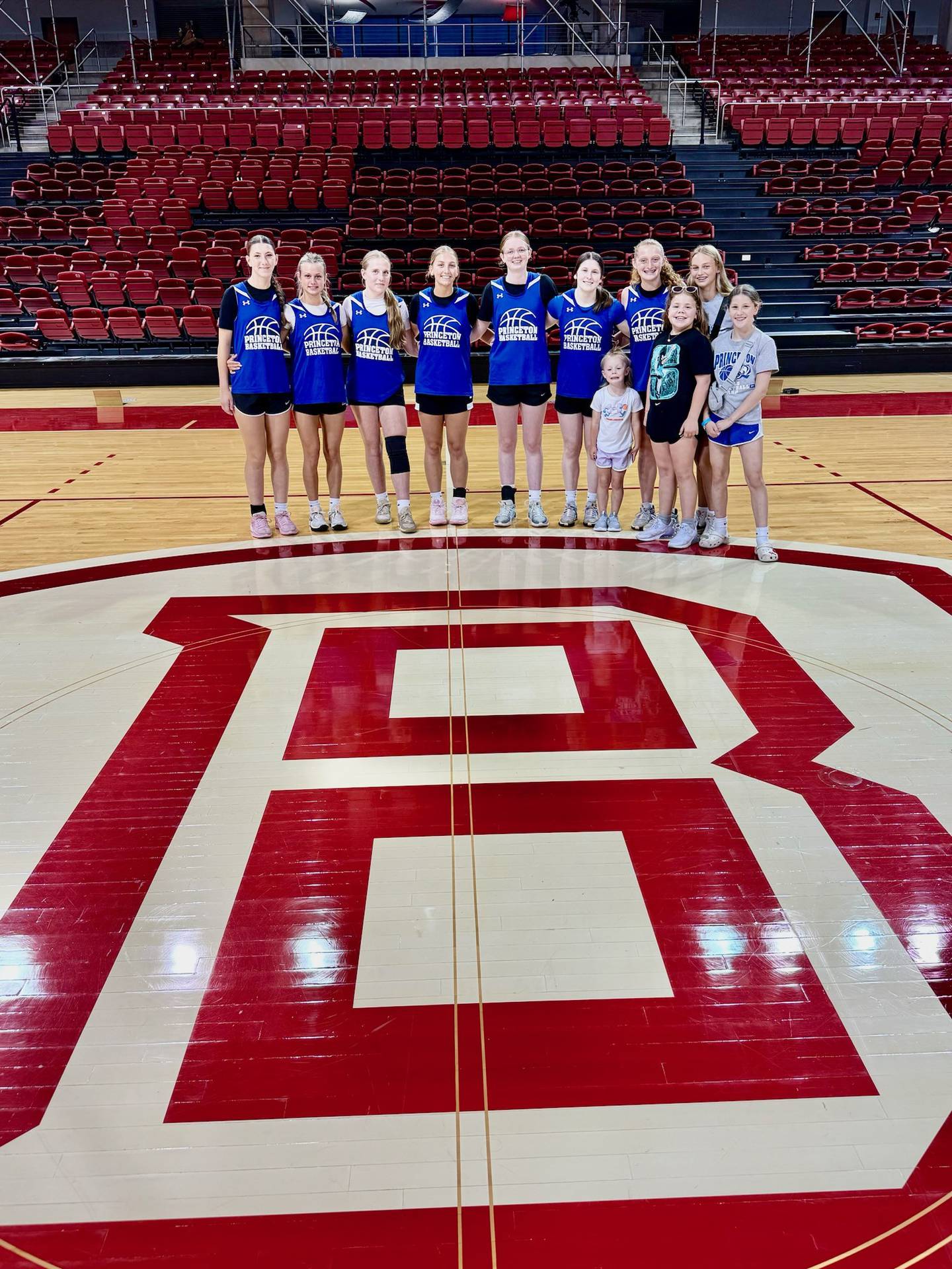 Princeton players and their young followers pose at the gym logo at the Bradley University Team Camp.