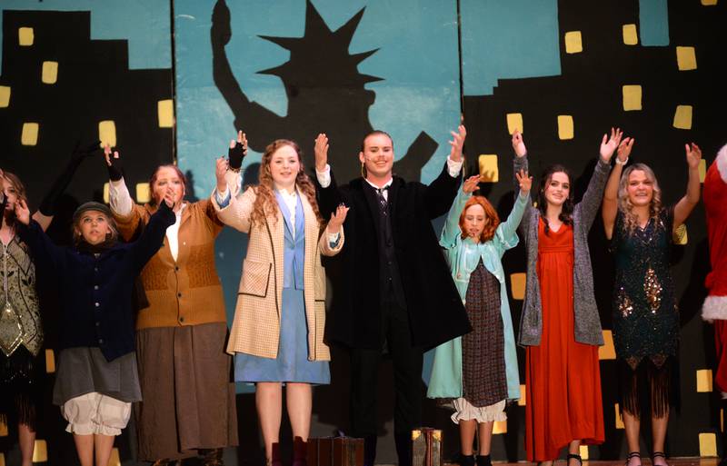 Orphan Annie (Lucy Schneiderman), Grace Farell (Zoriah Jenkins) and Oliver Warbucks (Dane Setterstrom) perform a musical number with other cast members during Forreston High School's performance of Annie on Sunday, April 28, 2024.