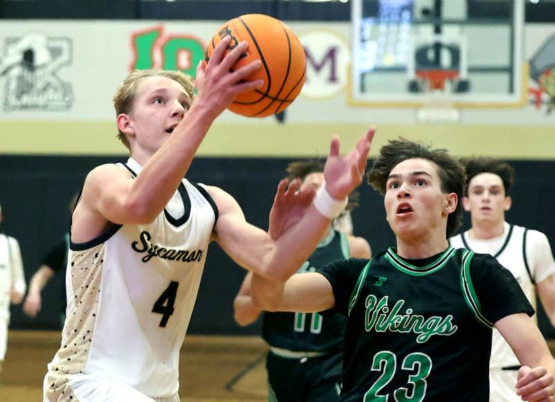 Sycamore's Isaiah Feuerbach gets to the basket ahead of North Boone's Michael Persson during their game Tuesday, Dec. 3, 2024, at Sycamore High School.