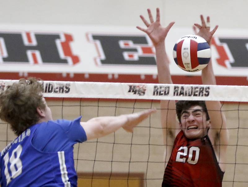 Huntley's Matthew Leith blocks the spike of St. Charles North's Carter Price during a nonconference boys volleyball match Monday, May 8, 2023, at Huntley High School.