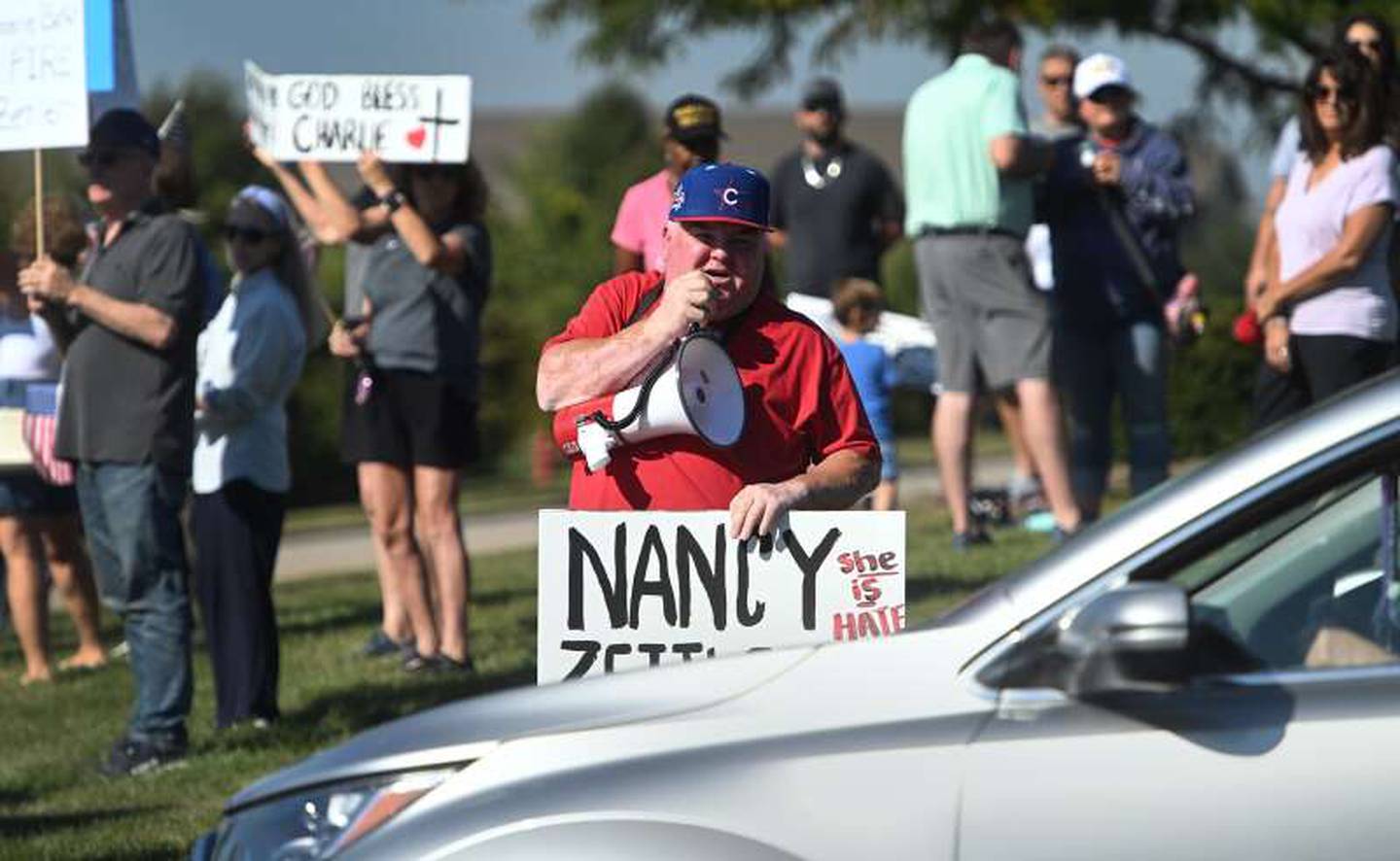 About 60 people participated in a protest on Monday, Sept. 15, 2025, at District 300 headquarters in Algonquin, demanding that school board president Nancy Zettler step down following a social media post related to the shooting death of activist Charlie Kirk.