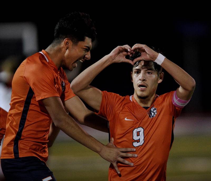 Romeoville’s Joseph Duarte gestures to the crowd as teammate Imanol Casillas laughs after he scored against York in the Class 3A semifinal game of the boys state soccer tournament in Hoffman Estates on Friday, November, 4, 2022.