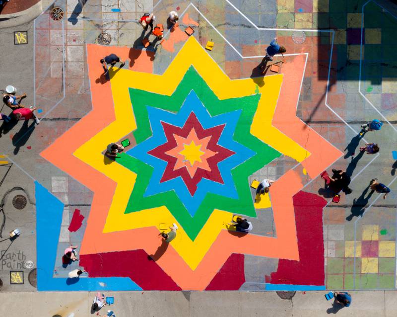 A multi colored street mural comes to life in the intersection of Walnut and Riverside Avenues during the St. Charles Art CouncilÕs ÒPaint the RiversideÓ event on Saturday, May 10, 2025 in St. Charles.