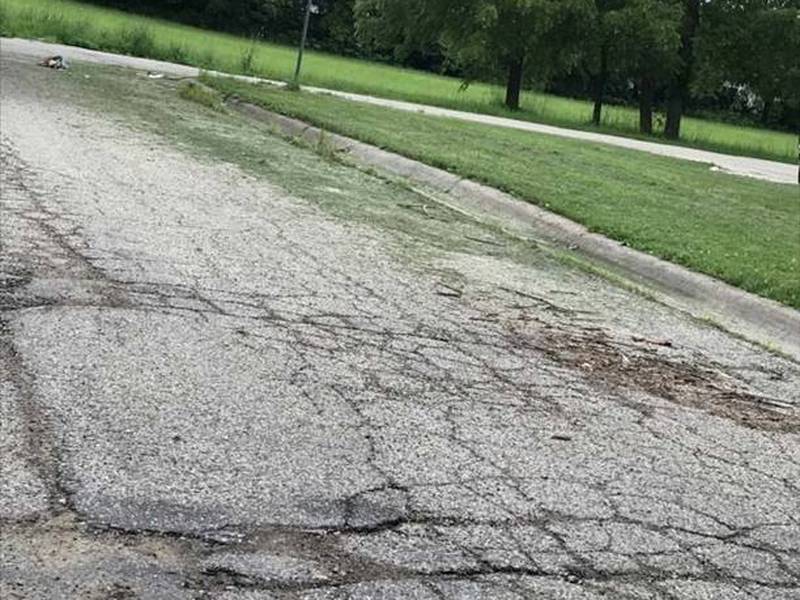 A road in need of repairs is shown in a Harvard subdivision.