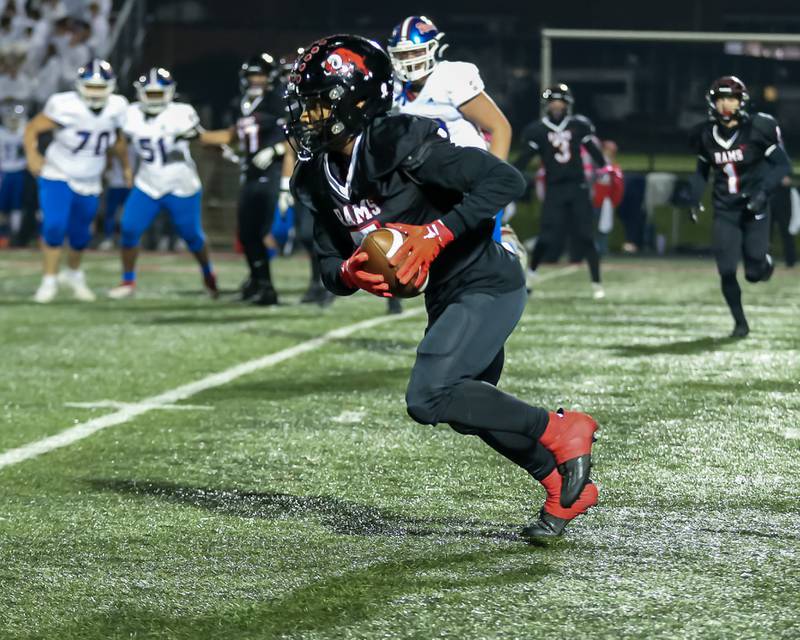 Glenbard East's Donte Hudson (5) runs after a catch during football game between Glenbard South at Glenbard East.   Oct 13, 2023.