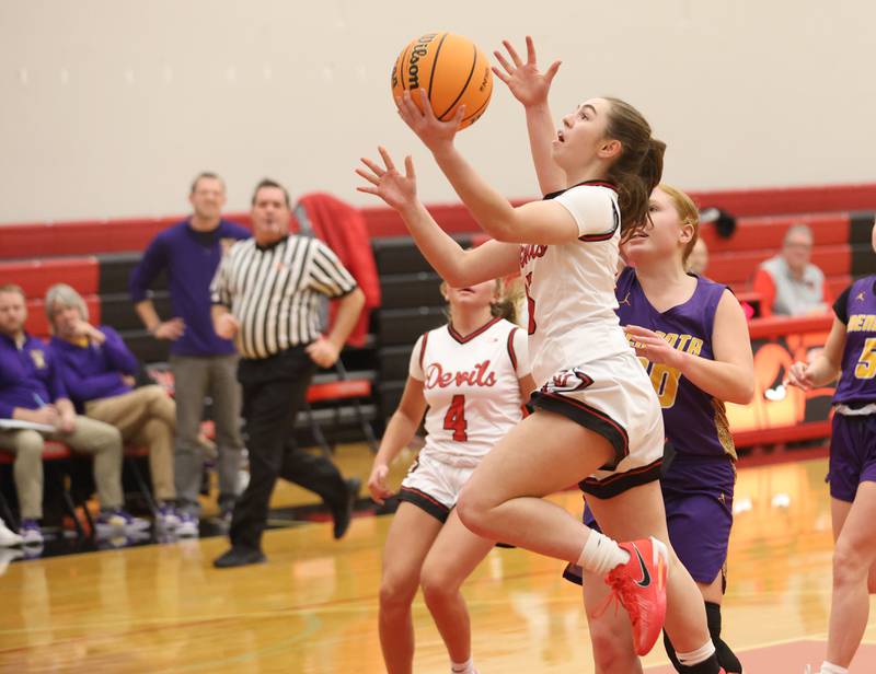 Hall's Bernadette Larsen runs in for a layup around Mendota's Emily Sondgeroth on Monday, Dec. 1, 2025 at Hall High School.