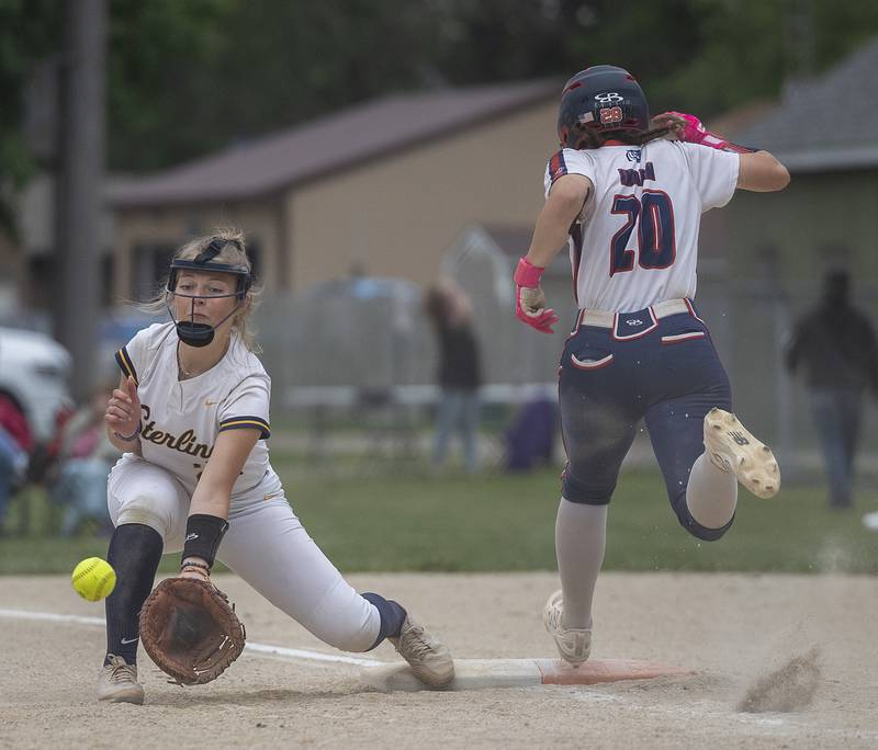 Sterling’s Georgia Gallardo is late making the catch as  Belvidere North’s Hallie Inman gets to first safely Friday, May 30, 2025, in the Class 3A Regional final in Dixon. The batter was called out on the play.
