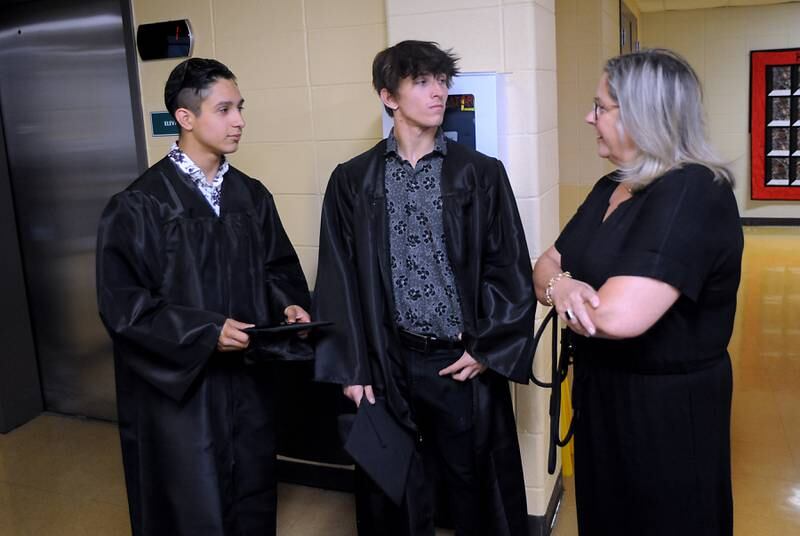 Giezi Jaramillo and Joshua Barendsen talks with teacher Anne Whitney-Turbidy Thursday, May 12, 2022, before the Haber Oaks Campus graduation in the courtyard of Crystal Lake South High School.