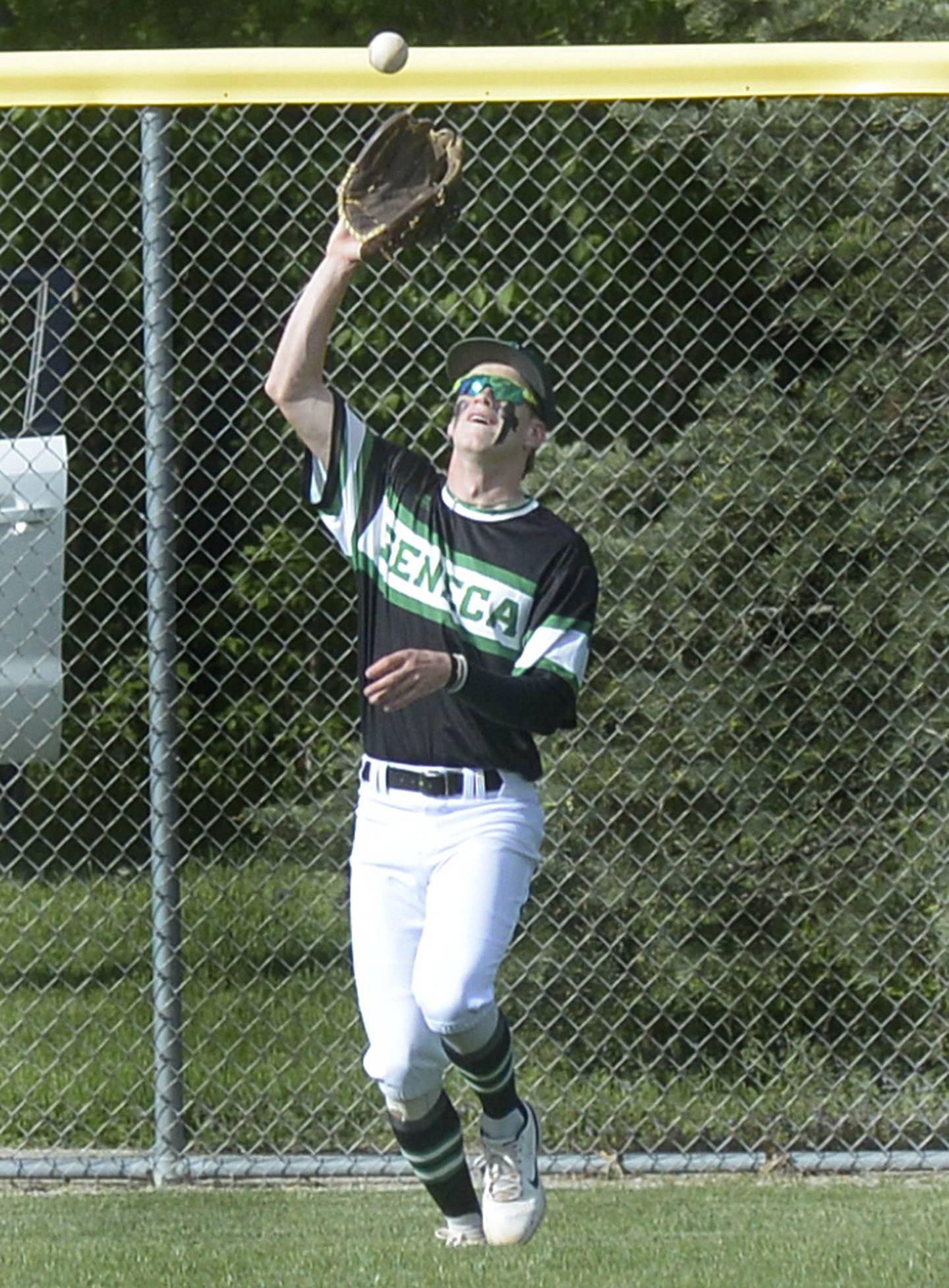 Seneca centerfielder Paxton Giertz camps under a fly ball near the warning track against Marquette in a game last season at Masinelli Field in Ottawa.