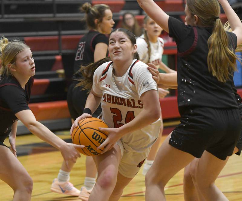 Forreston's Alice Kobler (24) draws contact as she drives between two Dakota defenders during a game on Friday, Feb. 6, 2026 at Forreston High School.