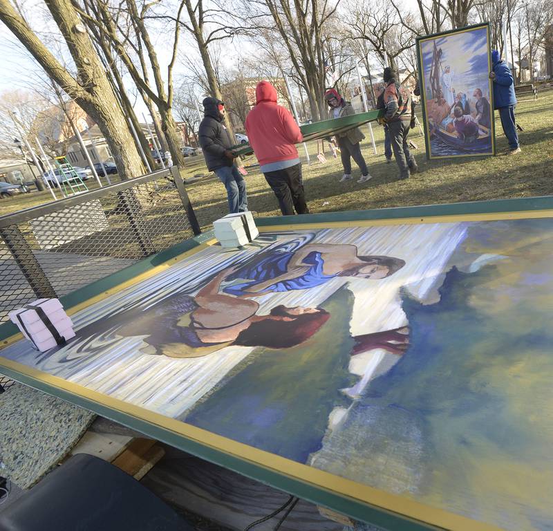 One of the 16 paintings depicting Jesus’ birth, life and ministry awaits to be erected Saturday in Ottawa’s Washington Square.