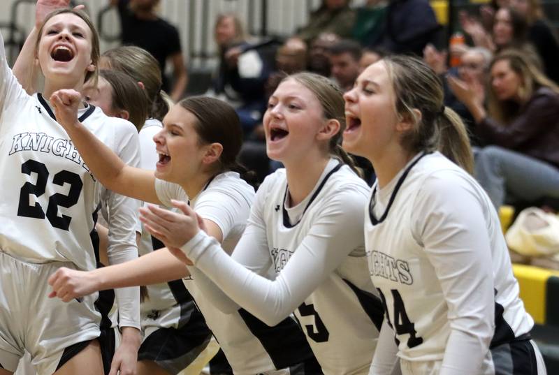 Kaneland’s Ansley Ruh, left, and the Knights celebrate a Kyra Lilly three-point shot in IHSA Class 3A Regional Title Game girls basketball action on Friday, Feb. 21, 2025, at Crystal Lake South High School in Crystal Lake.