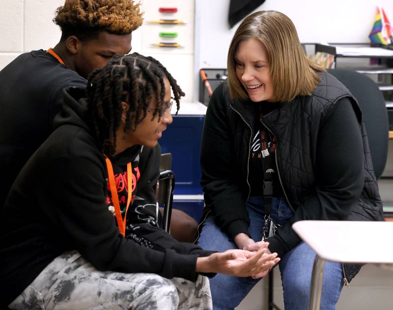 Jenni Smith, an eighth grade math teacher at Huntley Middle School, talks to a student Wednesday, March 19, 2025, in her class at the school in DeKalb.