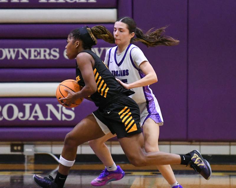Downers Grove North's Caitlin Sandridge, right, plays defense while St. Laurence's Ciyah Thomas (5) tries drive to the basket during the 4A Regional Championship game on Thursday Feb. 19, 2026, held at Downers Grove High School.