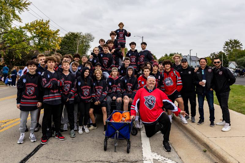 Members of the Plainfield High School Hockey Association – comprised of players from North, South, East, and Central – pose for a photo prior to the Plainfield Community Homecoming Parade on Sept. 28, 2024.