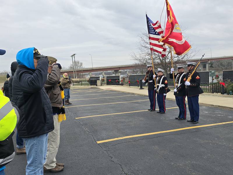 Veterans salute the Color Guard on Saturday, Dec. 14, 2024, at the Middle East Conflict Wall in Marseilles during the Wreaths Across America ceremony.