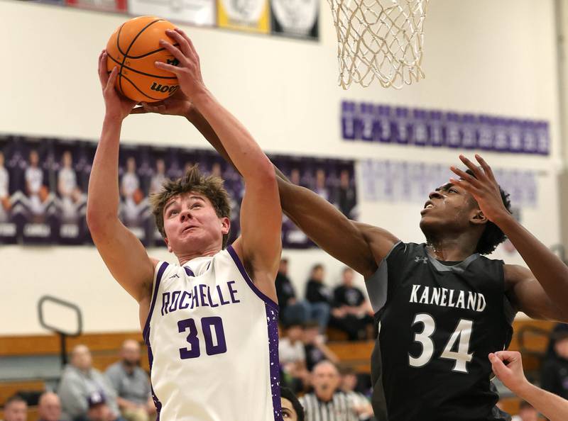 Rochelle's Warren Schwietzer grabs a rebound in front of Kaneland's Jeffrey Hassan Tuesday, Feb. 3, 2026, during their game at Rochelle High School.