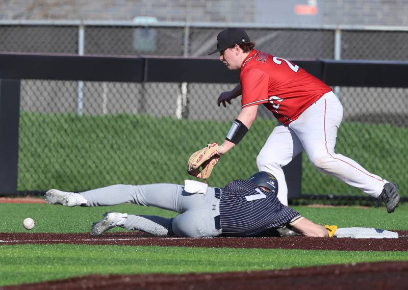Hiawatha's Tim Pruitt dives into third as South Beloit's Jaycee Schober tries to catch an errant throw Thursday, April 16, 2026, during their game at Northern Illinois University in DeKalb.