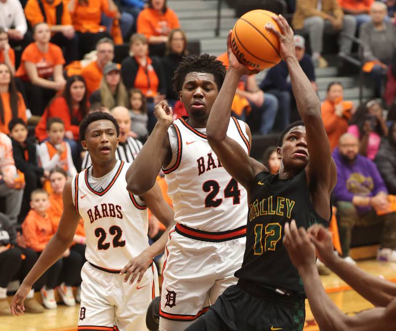 Waubonsie Valley's Tyreek Coleman gets up a shot in front of DeKalb's Myles Newman during their game Friday, Feb. 21, 2025, at DeKalb High School.