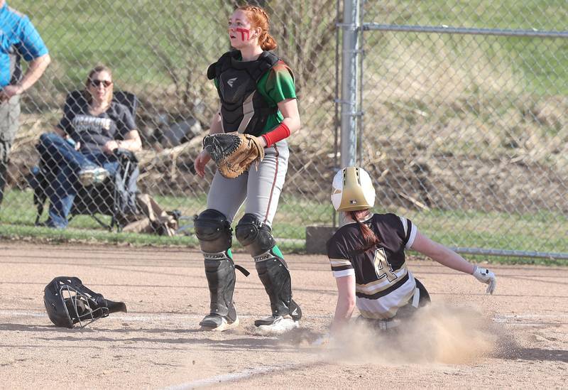 Sycamore's Tia Durst slides in behind LaSalle-Peru's Addison Duttlinger with the game’s first run during their game Tuesday, April 11, 2023, at Sycamore High School.